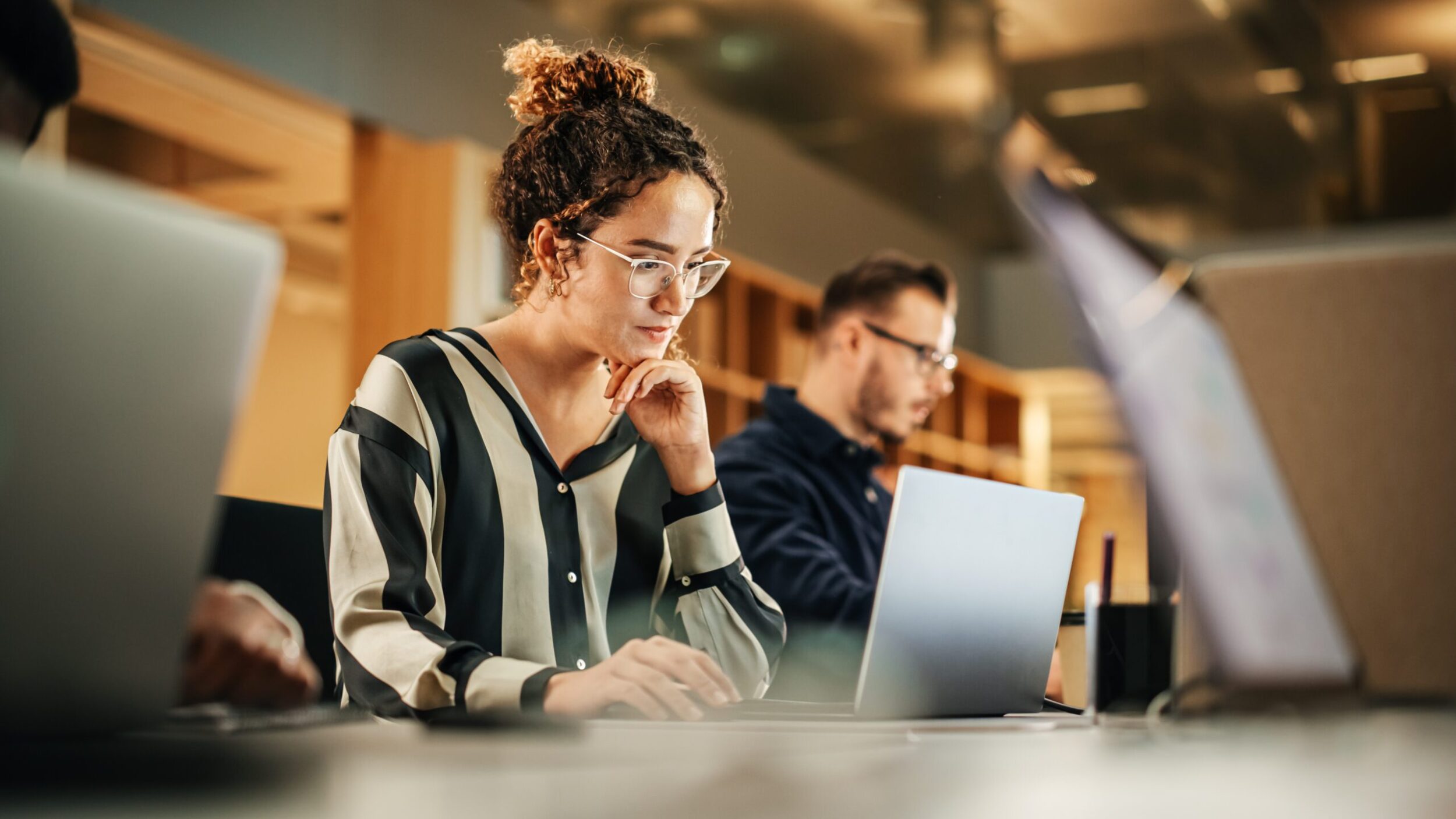 Portrait of Enthusiastic Hispanic Young Woman Working on Compute Portrait of Enthusiastic Hispanic Young Woman Working on Compute